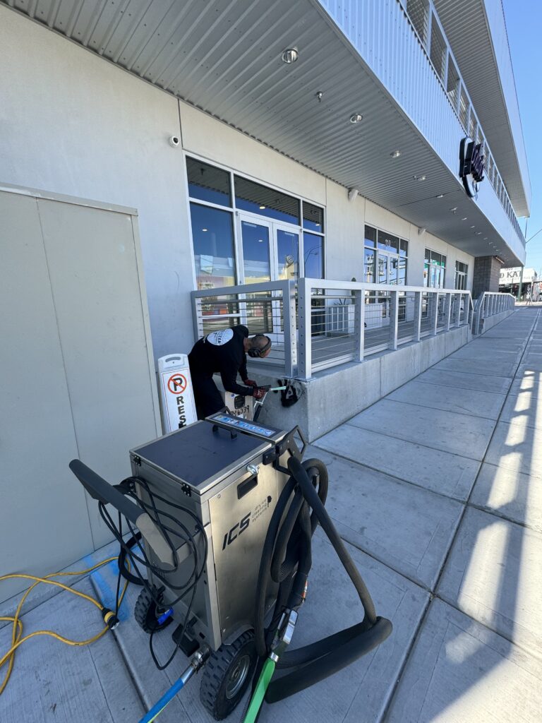 A technician from Dri-Clean Restorations uses an ice blasting machine to remove graffiti in Downtown Las Vegas.